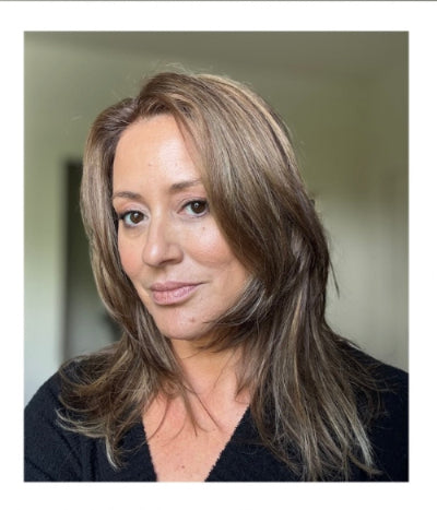 Woman with shoulder-length hair against a neutral background